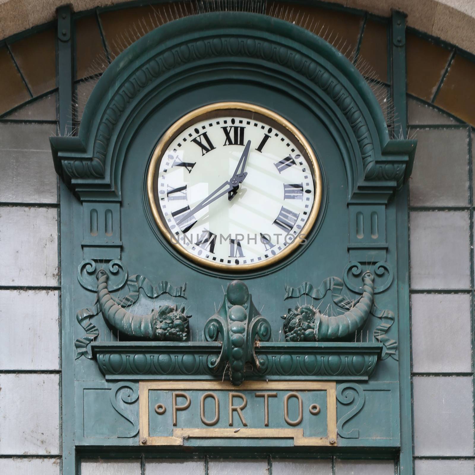 Old clock at railway station in Porto, Portugal

