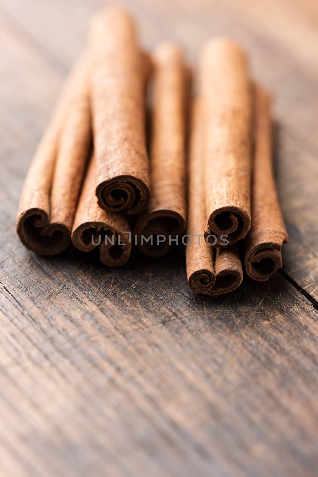 Cinnamon sticks on rustic wooden background