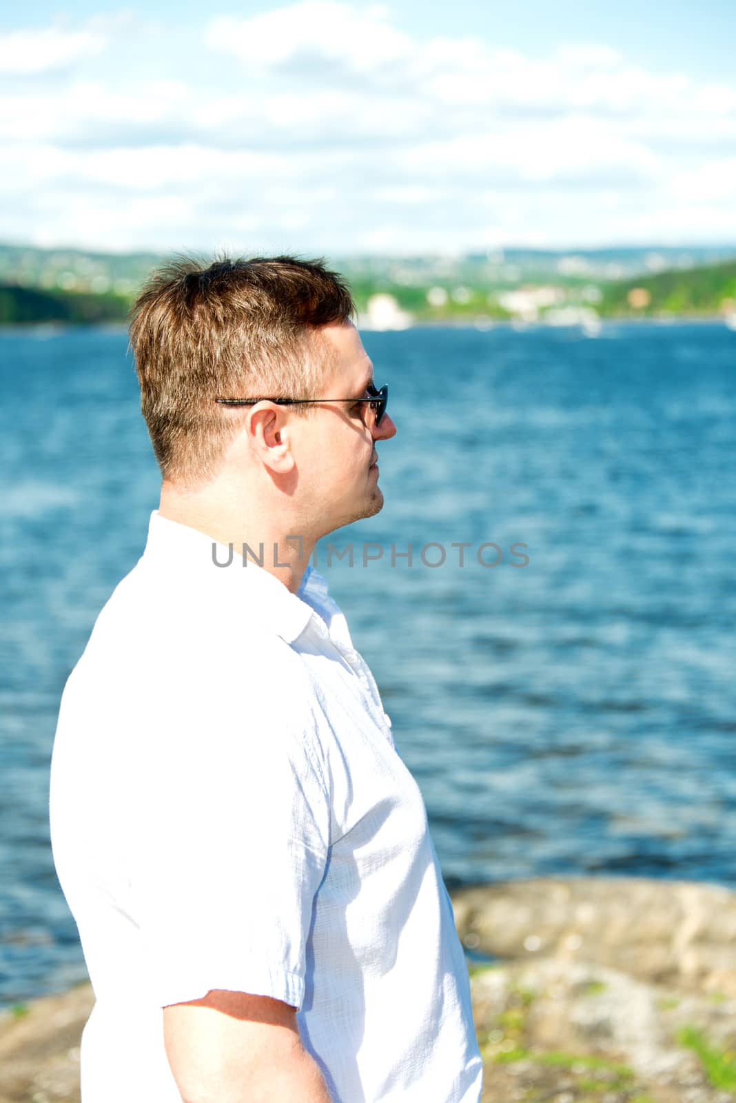 Middle aged man portrait with sea at background