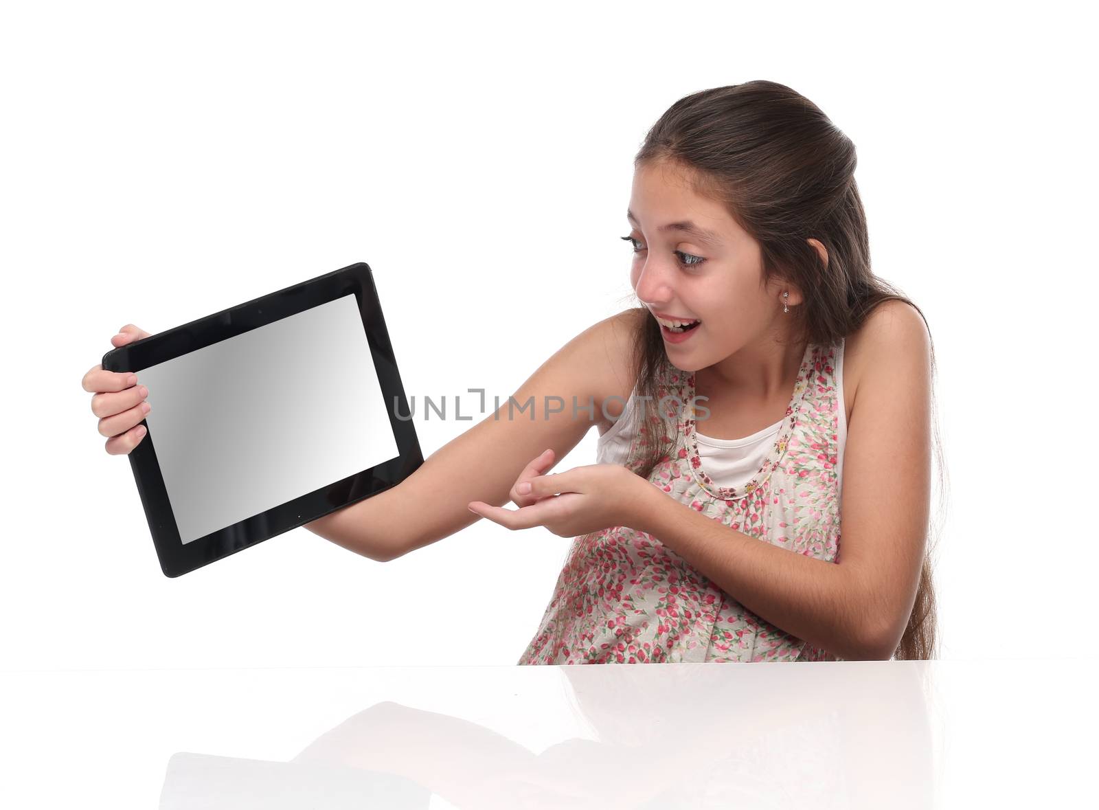 Beautiful pre-teen girl with a tablet computer. Isolated. Clipping path for the screen