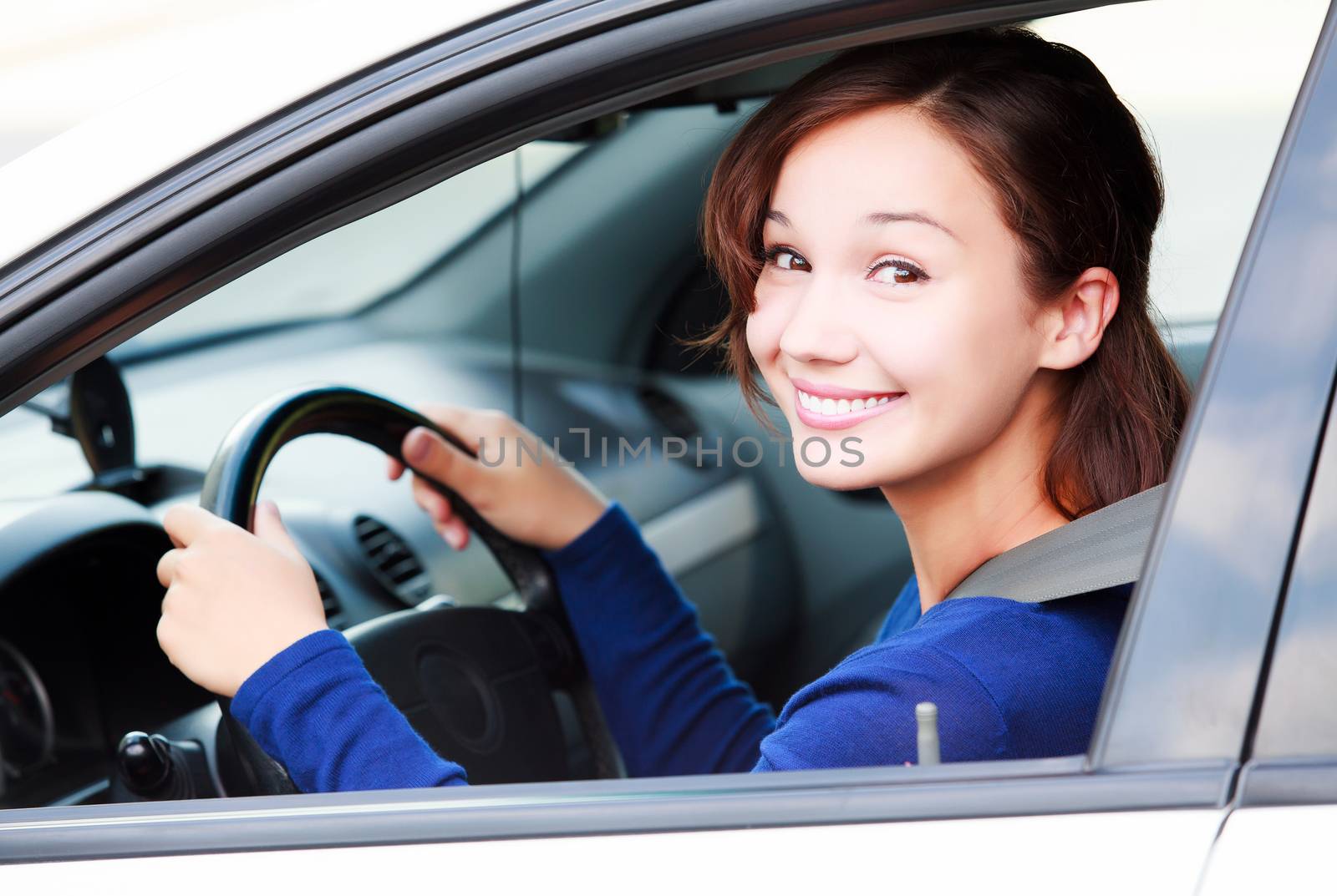 Happy female driver smiling to you