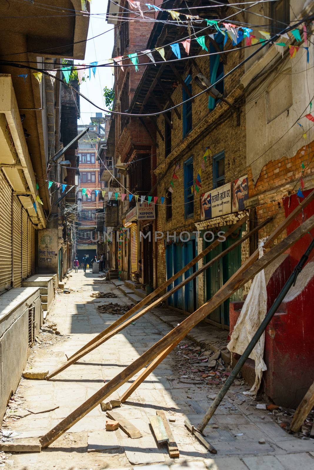 KATHMANDU, NEPAL - MAY 14, 2015: A small alley off Freak Street where wood beams support damaged buildings after two major earthquakes hit Nepal in the past weeks.