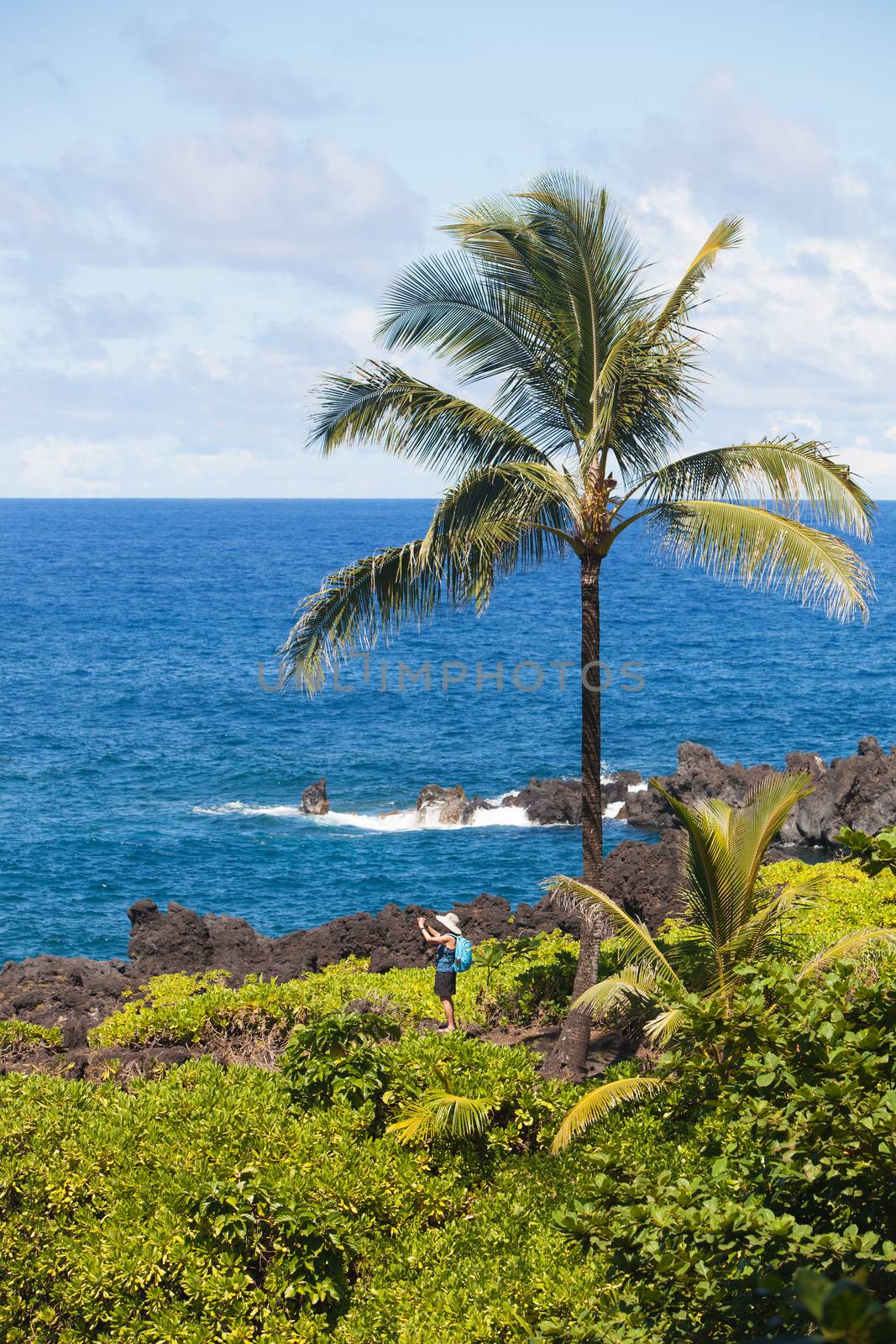Tourist taking photo near Hana on Maui