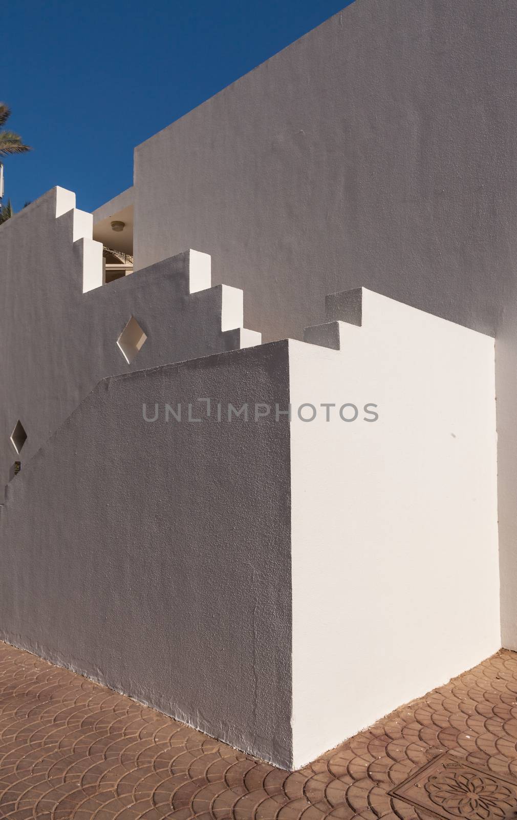 The small part of the white facade of the building in Egypt. side view