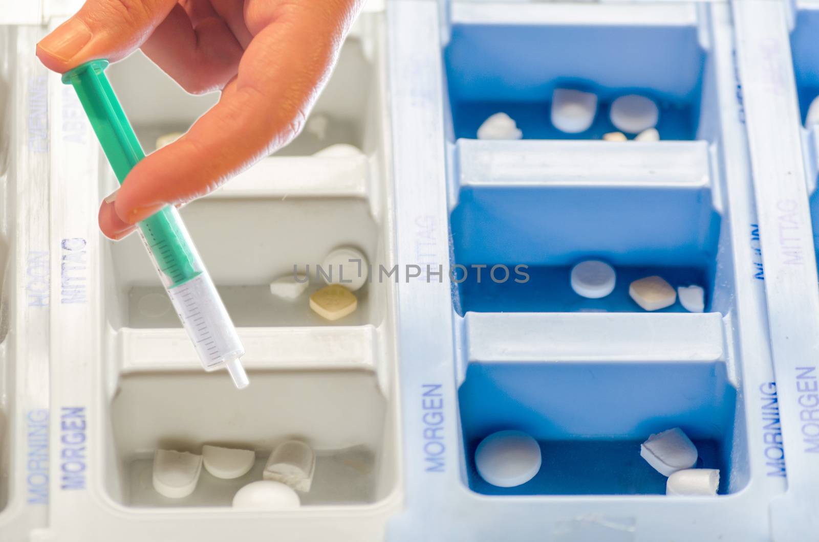 Medications in a plastic box with inscription.