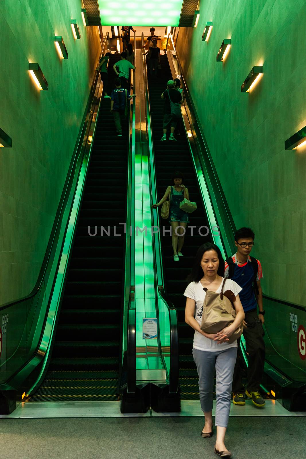People using the escalator in CKE Shopping Mall, Nathan Road, Hong kong , China, 20 june, 2013
