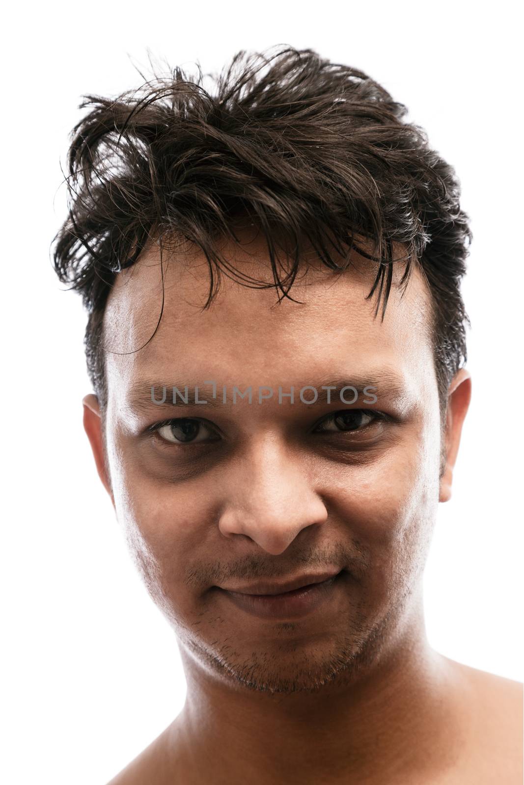 Close up portrait of a handsome young indian man smiling over white background