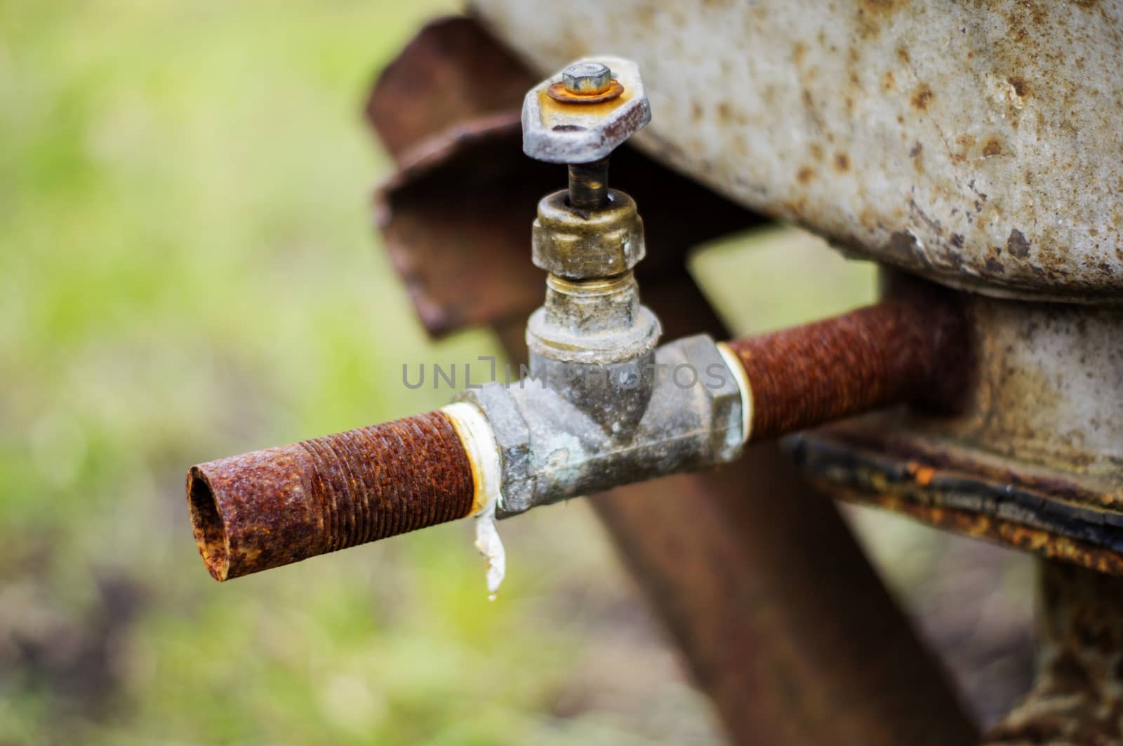 old rusty industrial tap water pipe and valve. For your commercial editorial use. by serhii_lohvyniuk