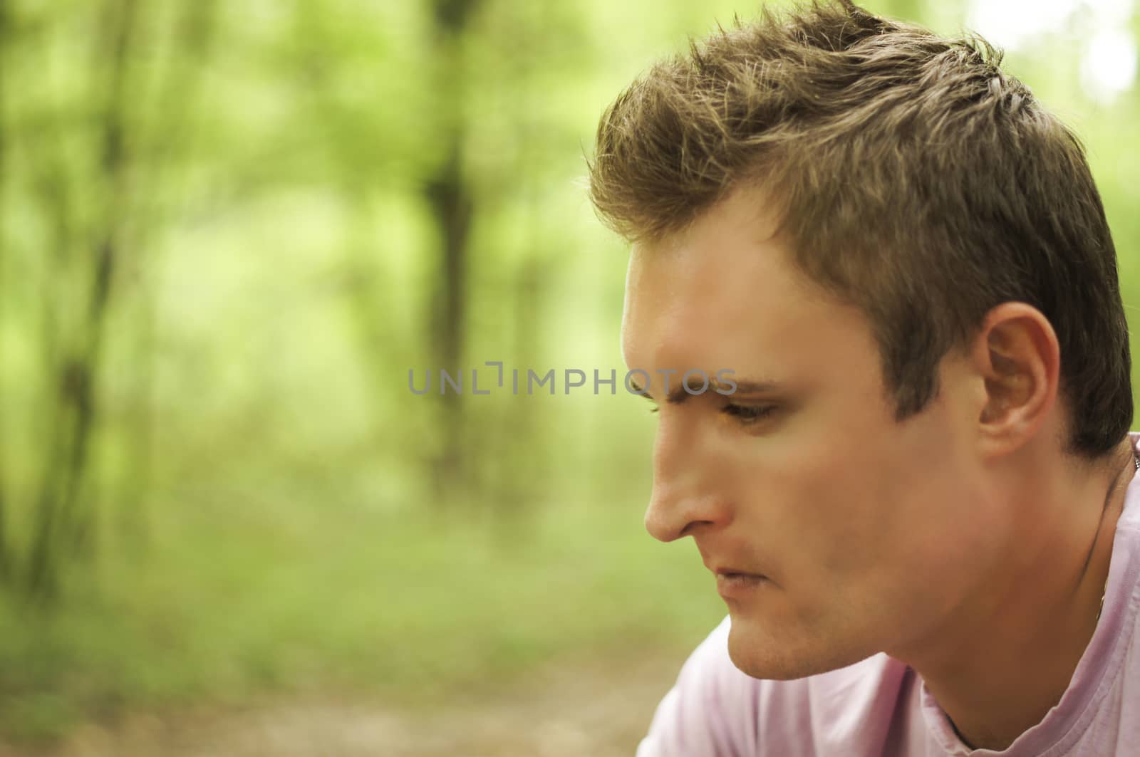 Thoughtful young man Outdoors. For your commercial and editorial use by serhii_lohvyniuk