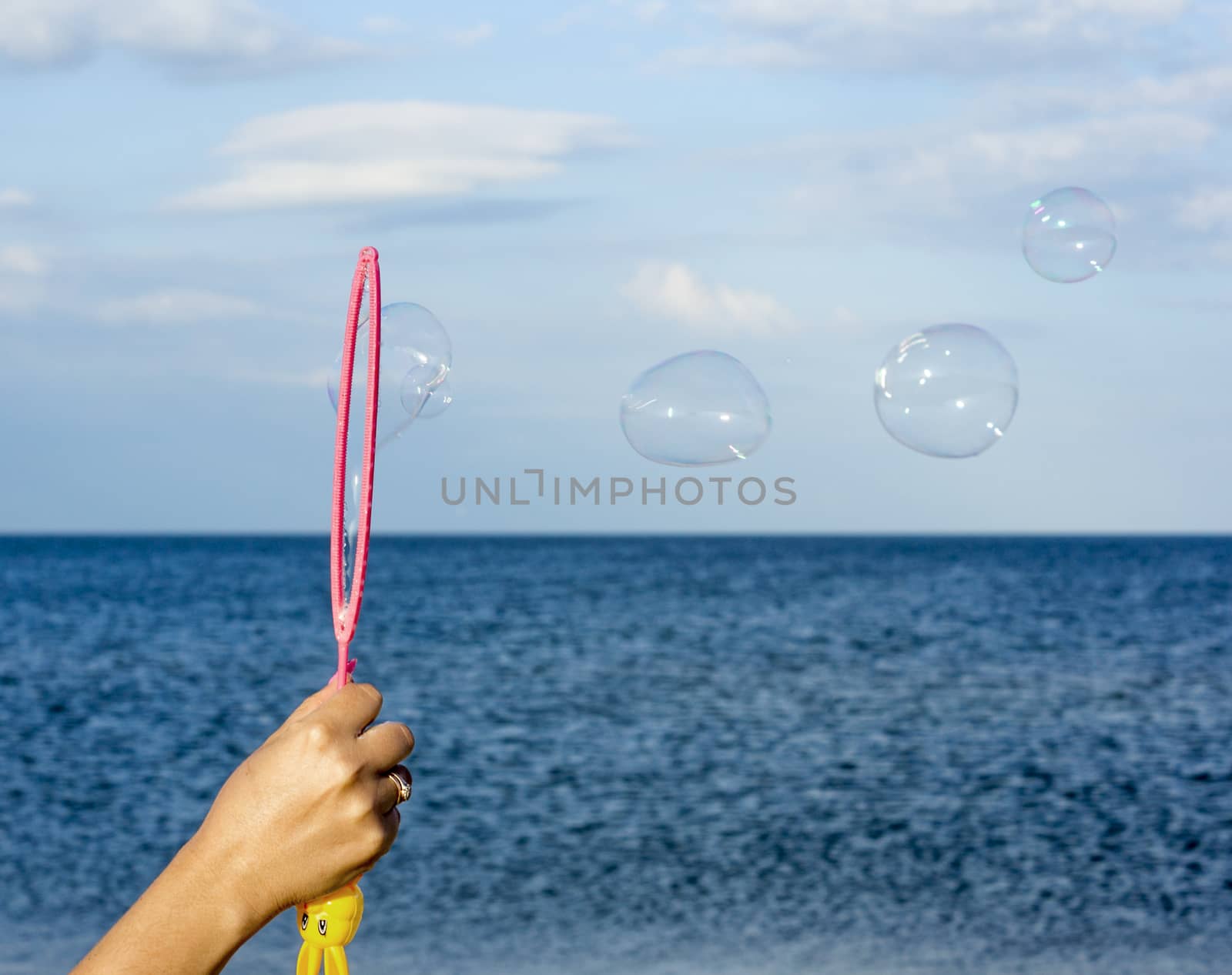 Colorful Soap Bubbles Against Blue Sky Background by serhii_lohvyniuk