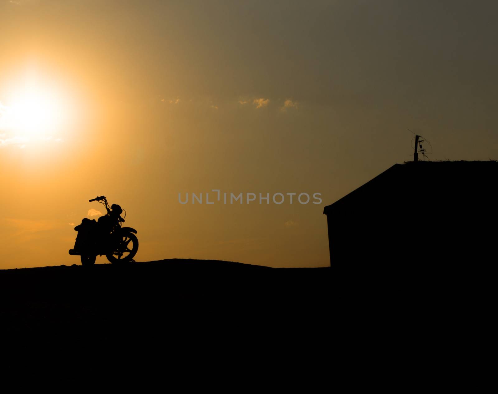 Motorcycle silhouette against the sunset by serhii_lohvyniuk