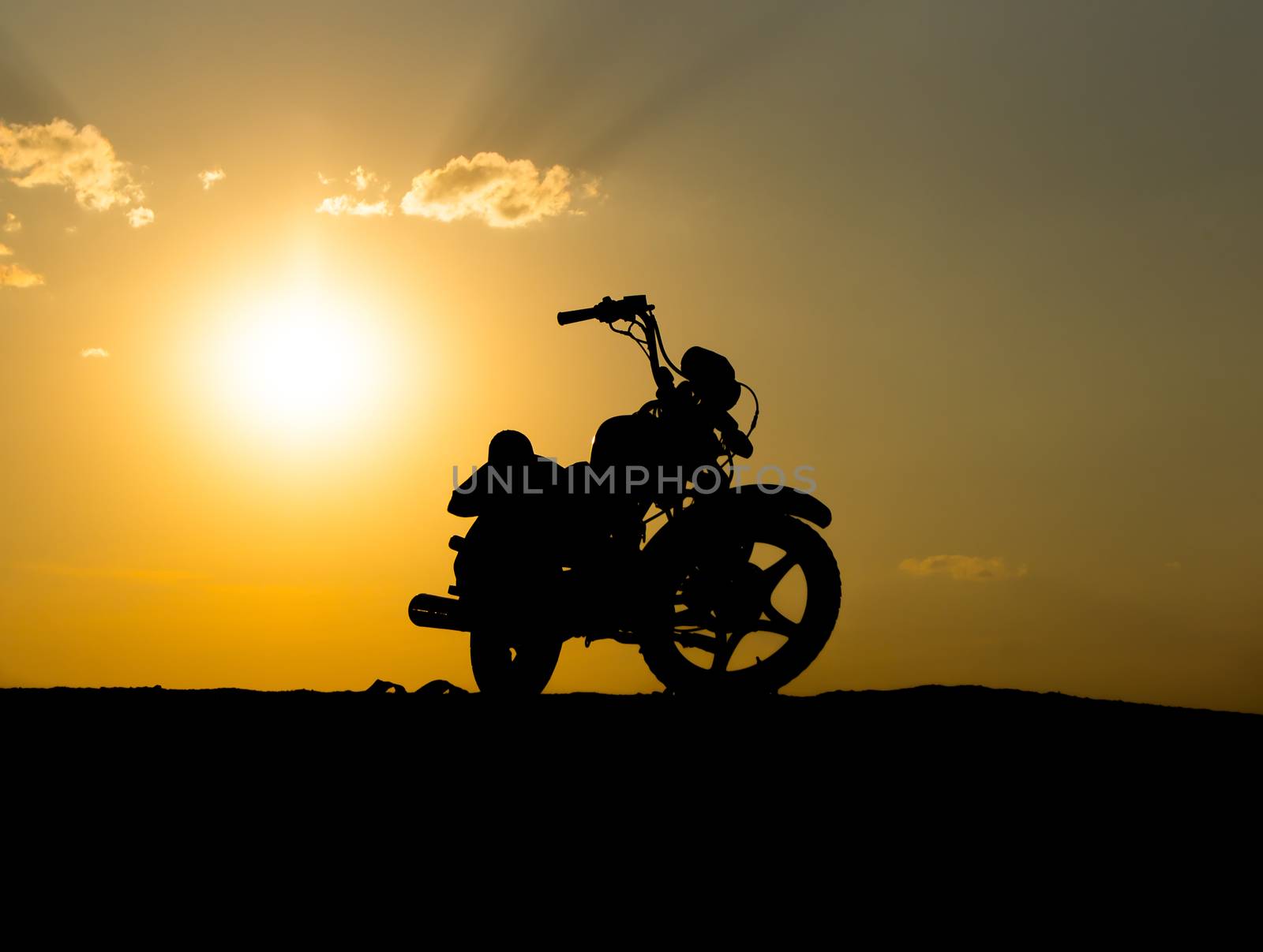 Silhouette of a motorcycl on a background of dark sky