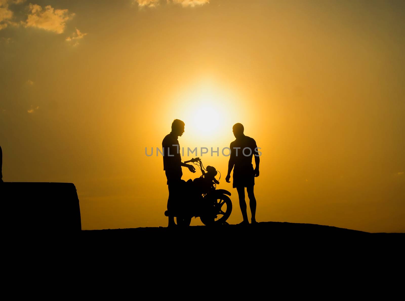 Silhouette of a motorcyclist on a background of dark sky. For your commercial and editorial use.
