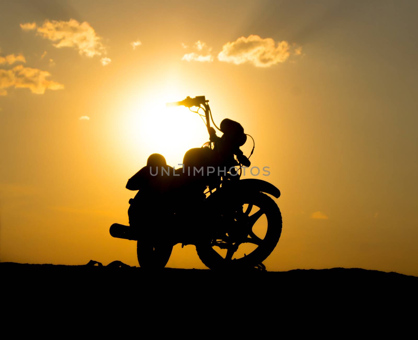Silhouette of a motorcycl on a background of dark sky. For your commercial and editorial use.