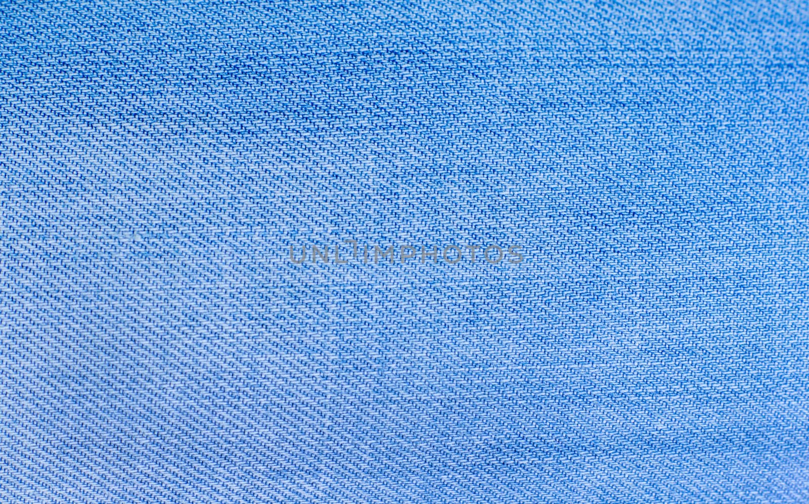 Texture of blue jeans textile close up by serhii_lohvyniuk