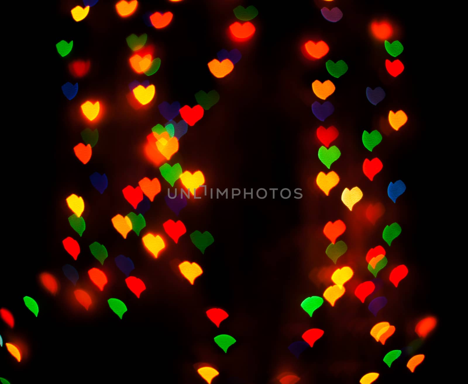 Defocused background lights or bokeh in the form of heart.