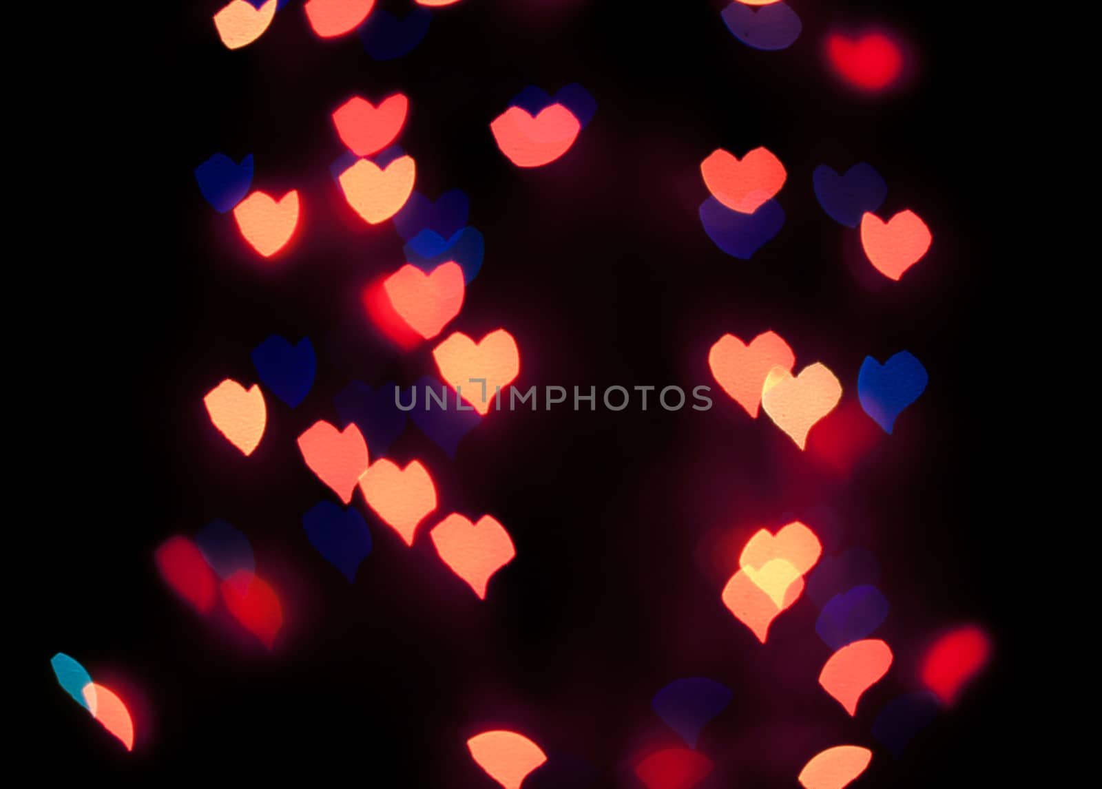 Defocused background lights or bokeh in the form of heart.
