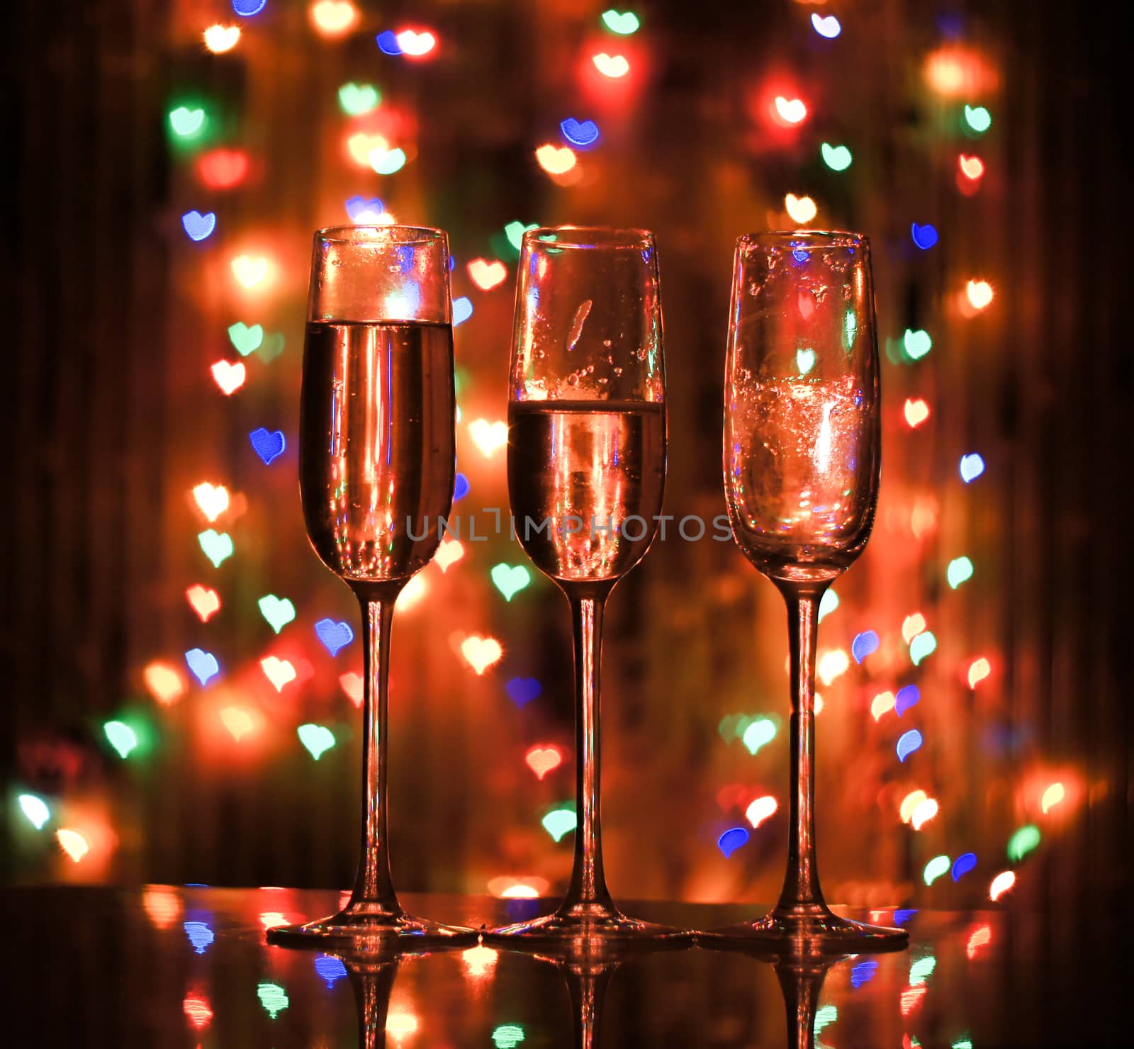 A glass of champagne on the background bokeh. For your commercial and editorial use.