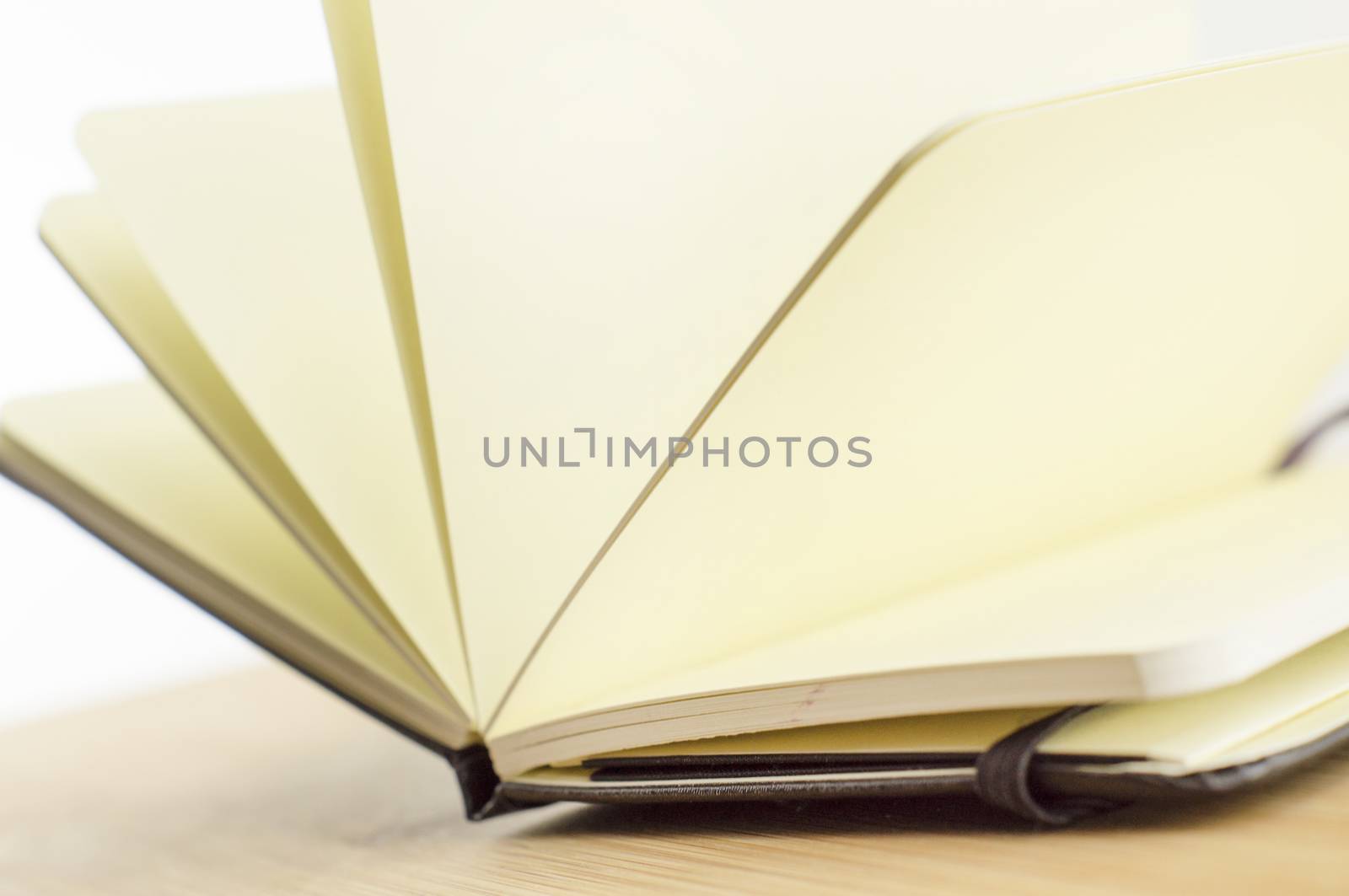 open book with incident light from the side on desk by serhii_lohvyniuk