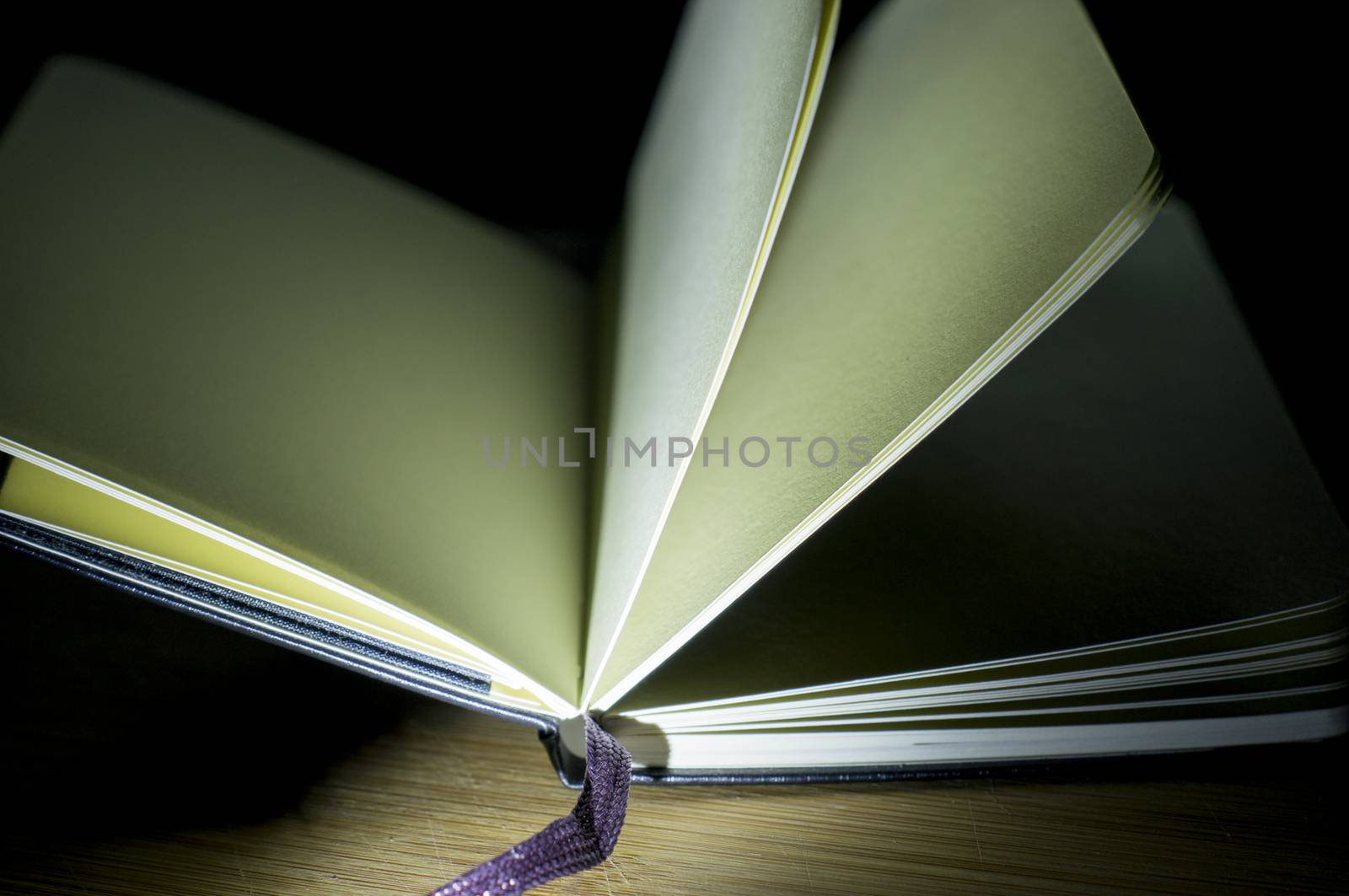 open book with the incident light from the side on desk.