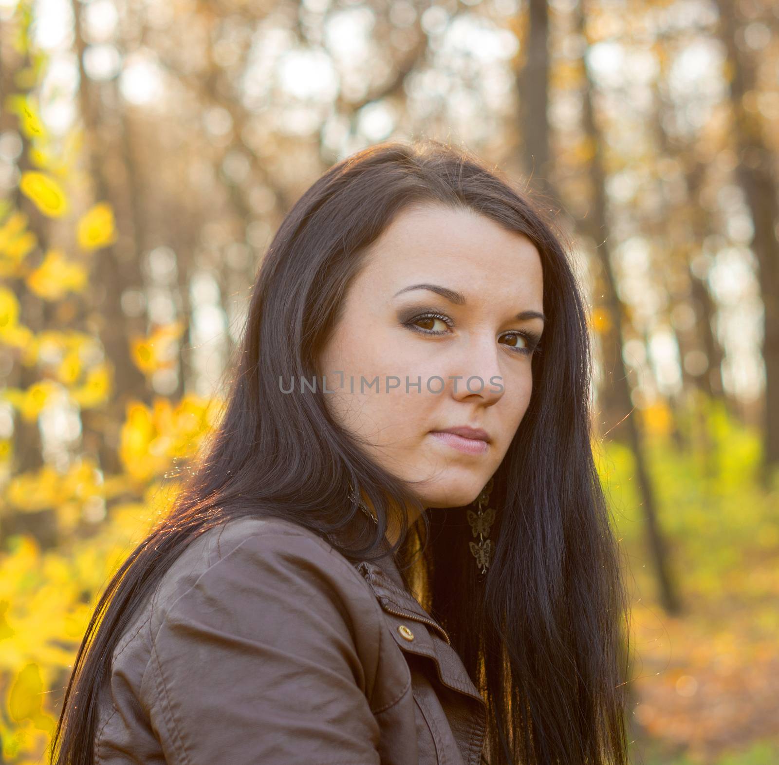 Young pretty woman in autumn park by serhii_lohvyniuk