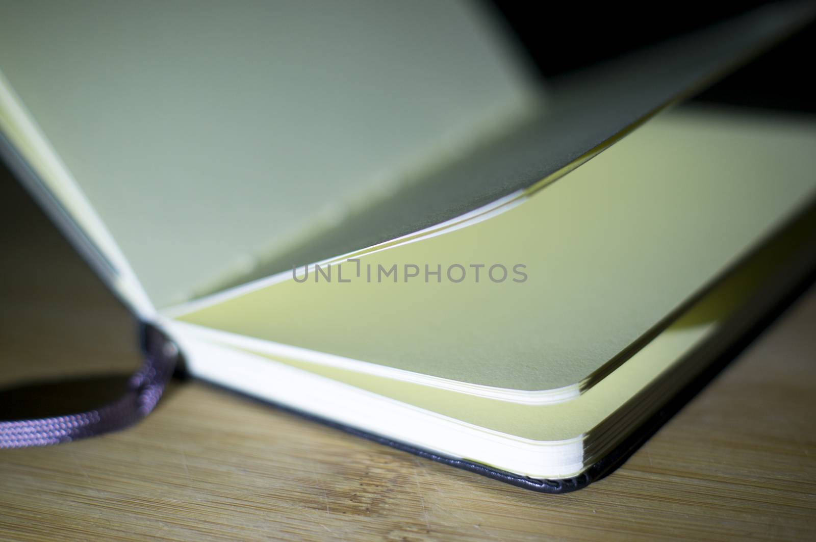 open book with the incident light from the side on desk.