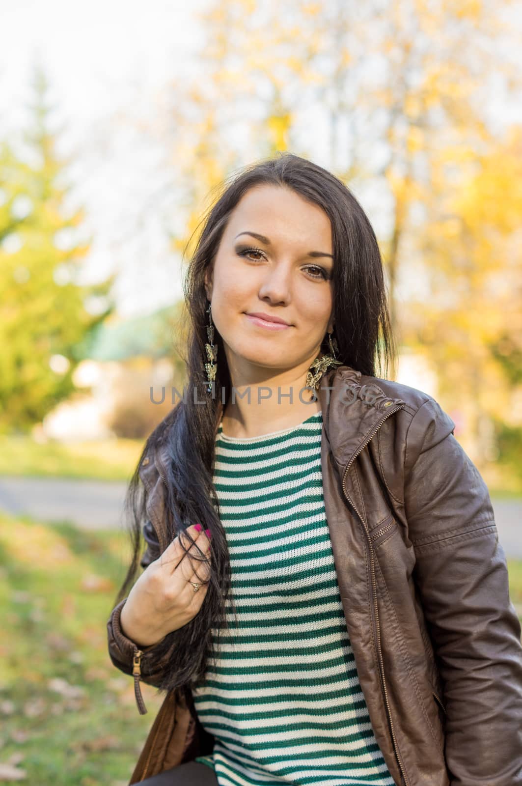 beautiful and sexy girl sitting on bench outdoors. 