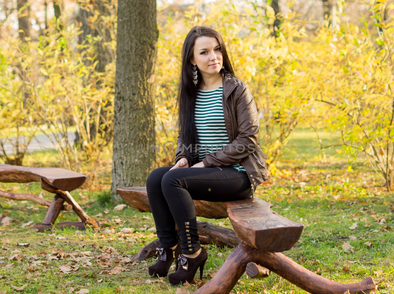 girl sitting on bench outdoors by serhii_lohvyniuk