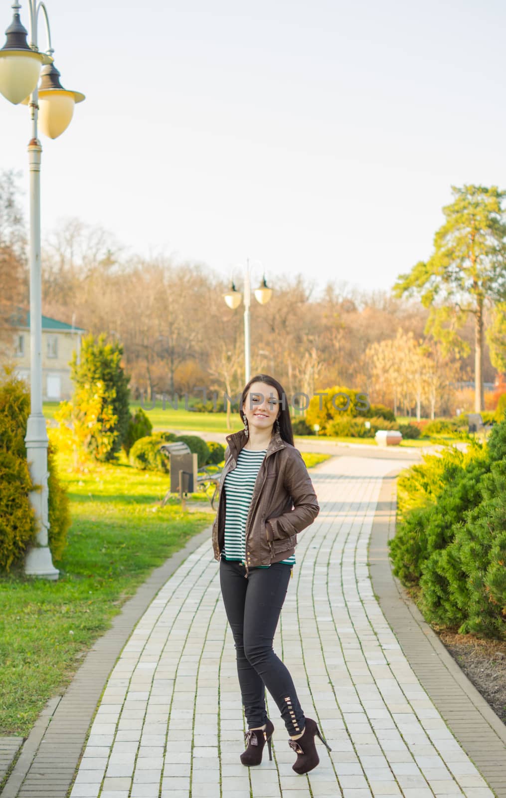 beautiful and sexy girl sitting on bench outdoors. 