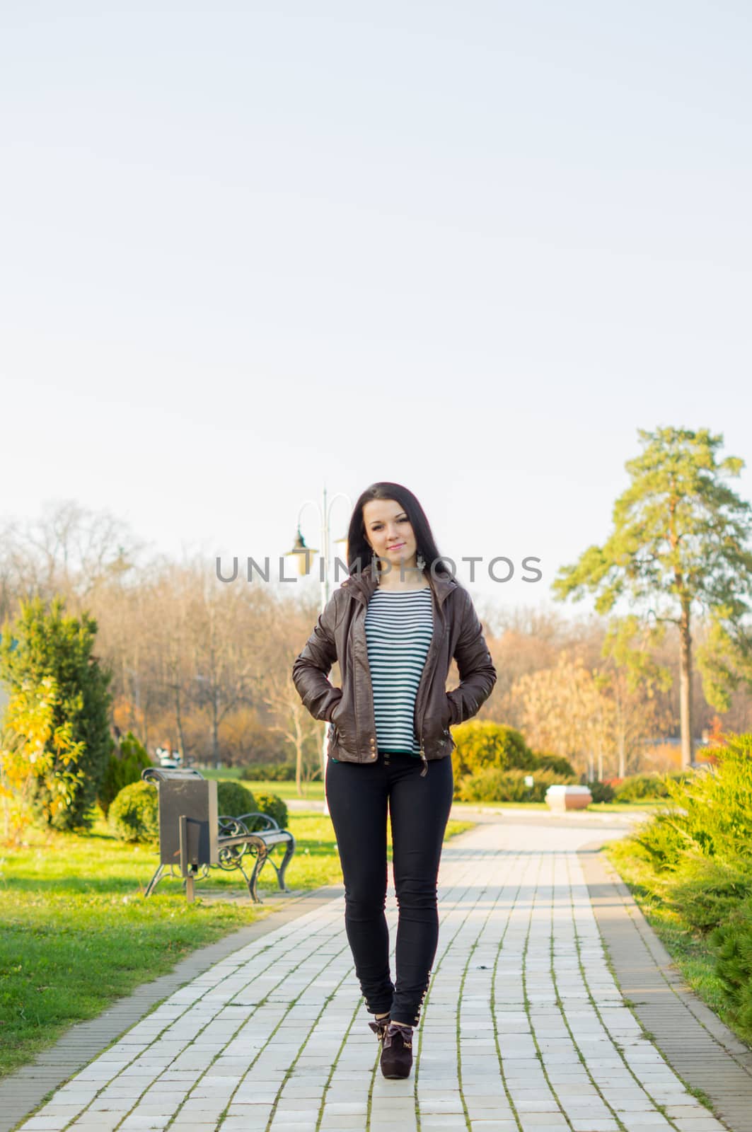 beautiful and sexy girl sitting on bench outdoors by serhii_lohvyniuk