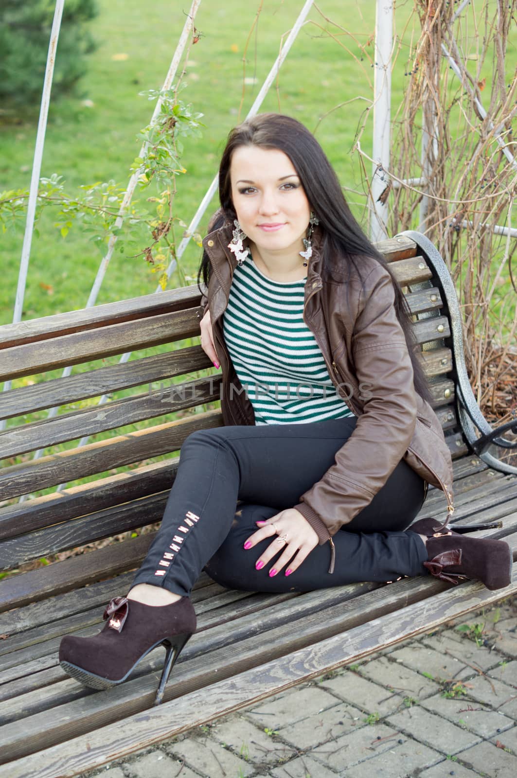 beautiful and sexy girl sitting on bench outdoors by serhii_lohvyniuk