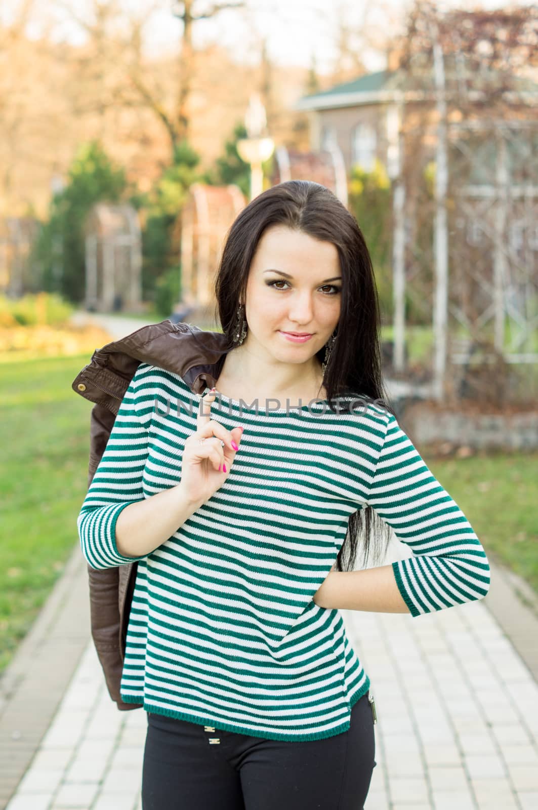 beautiful and sexy girl sitting on bench outdoors. 