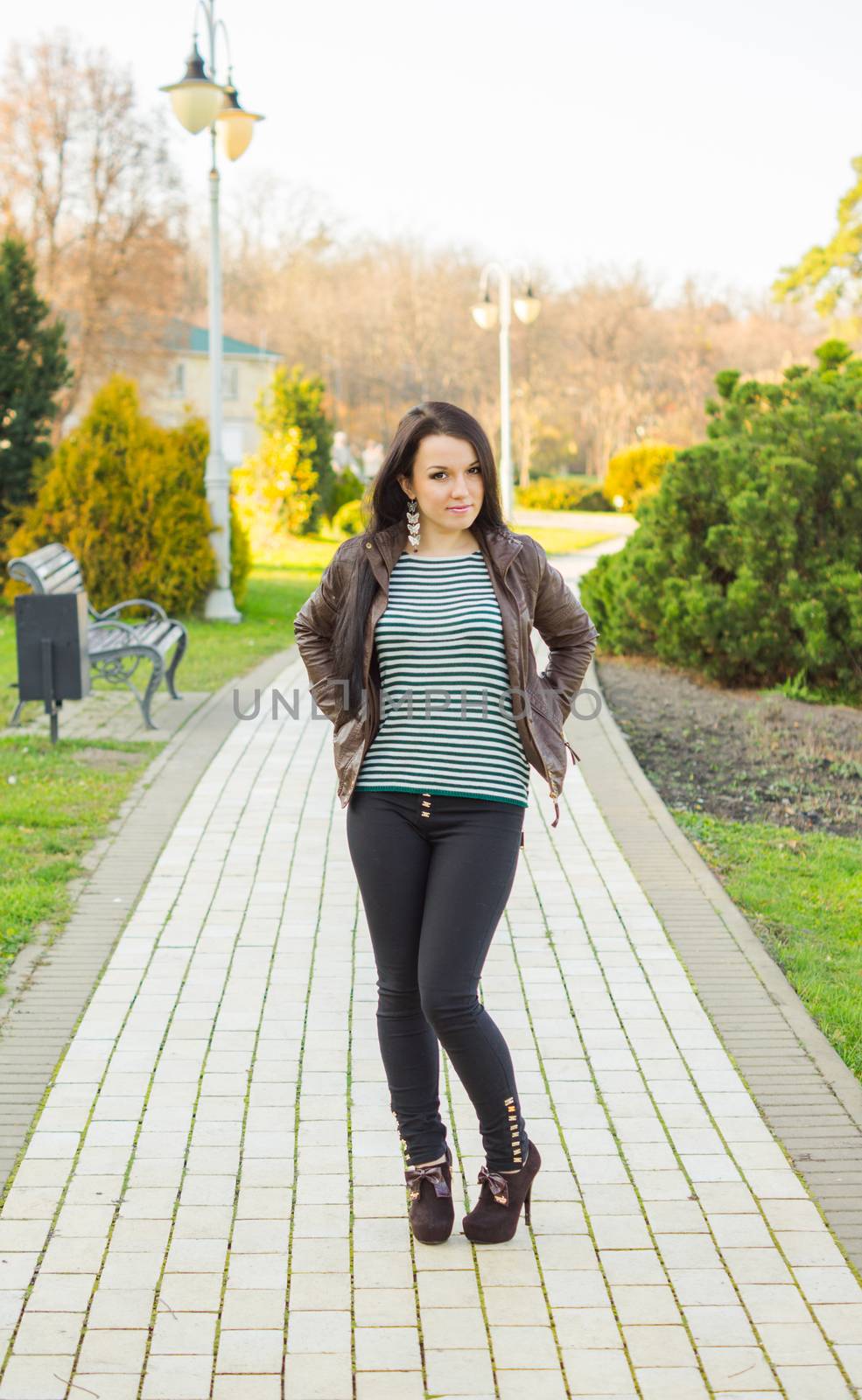 beautiful and sexy girl sitting on bench outdoors. 