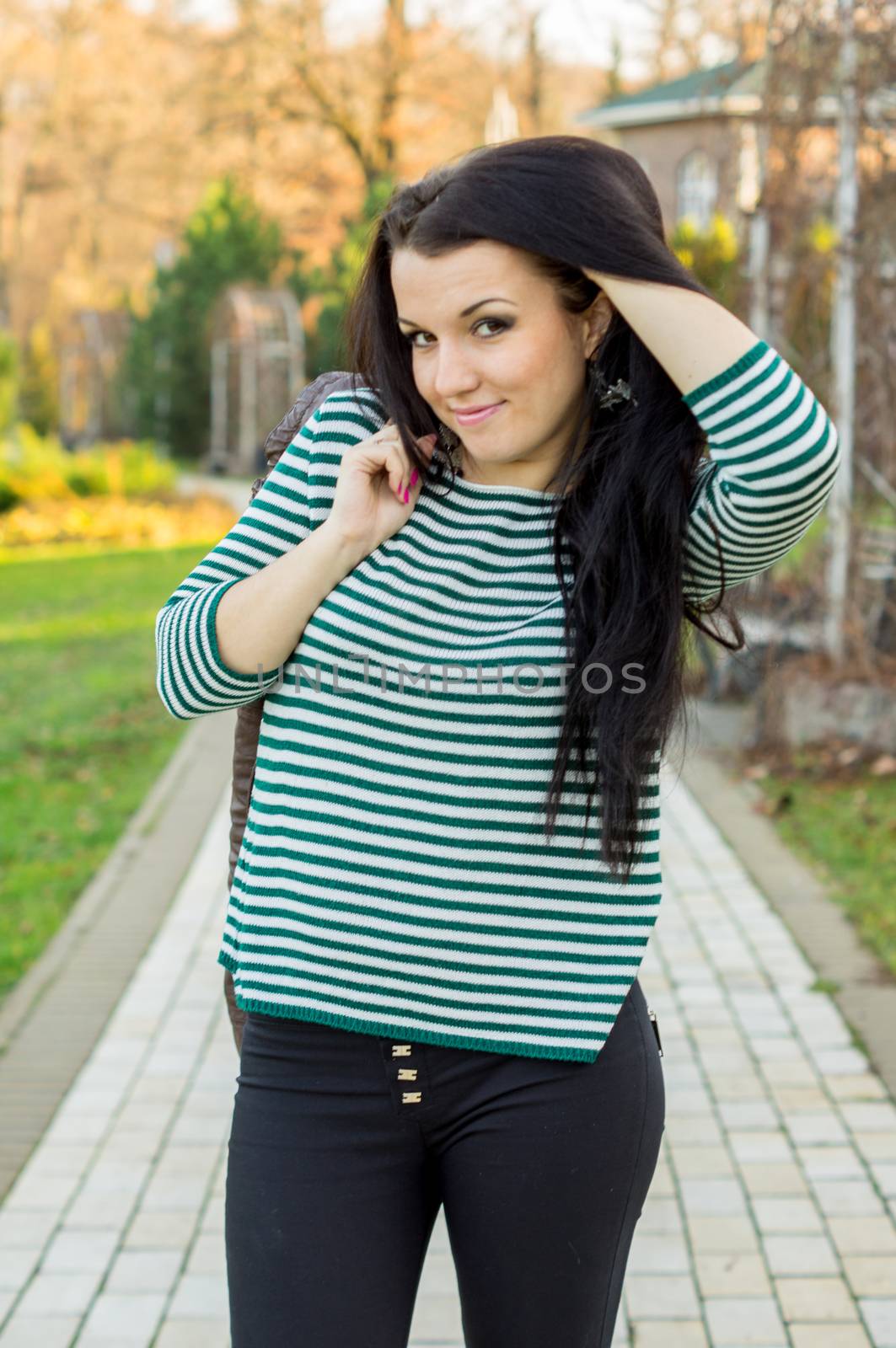 beautiful and sexy girl sitting on bench outdoors. 