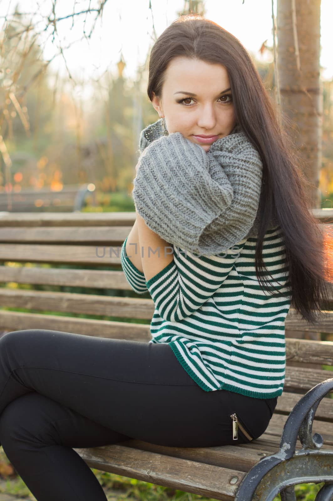 beautiful and sexy girl sitting on bench outdoors. 