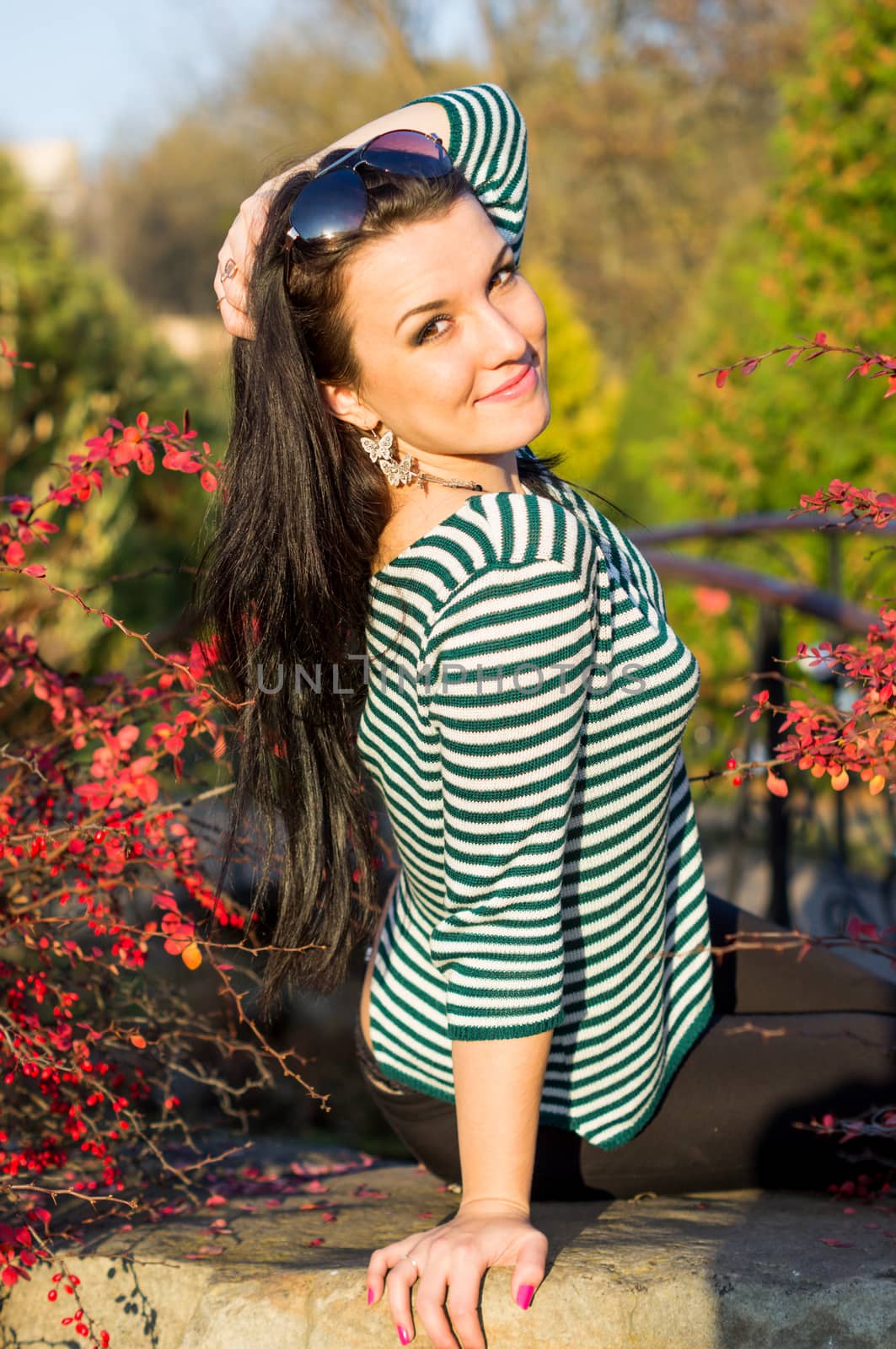 beautiful and sexy girl sitting on bench outdoors. 