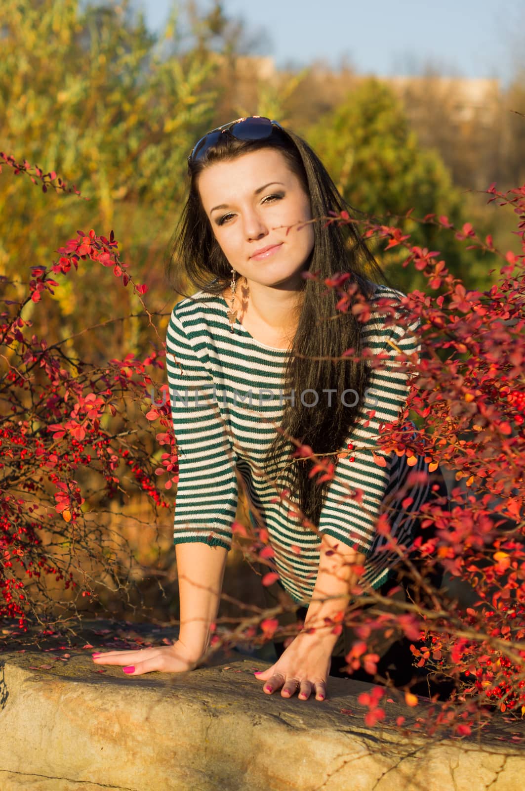 beautiful and sexy girl sitting on bench outdoors. 