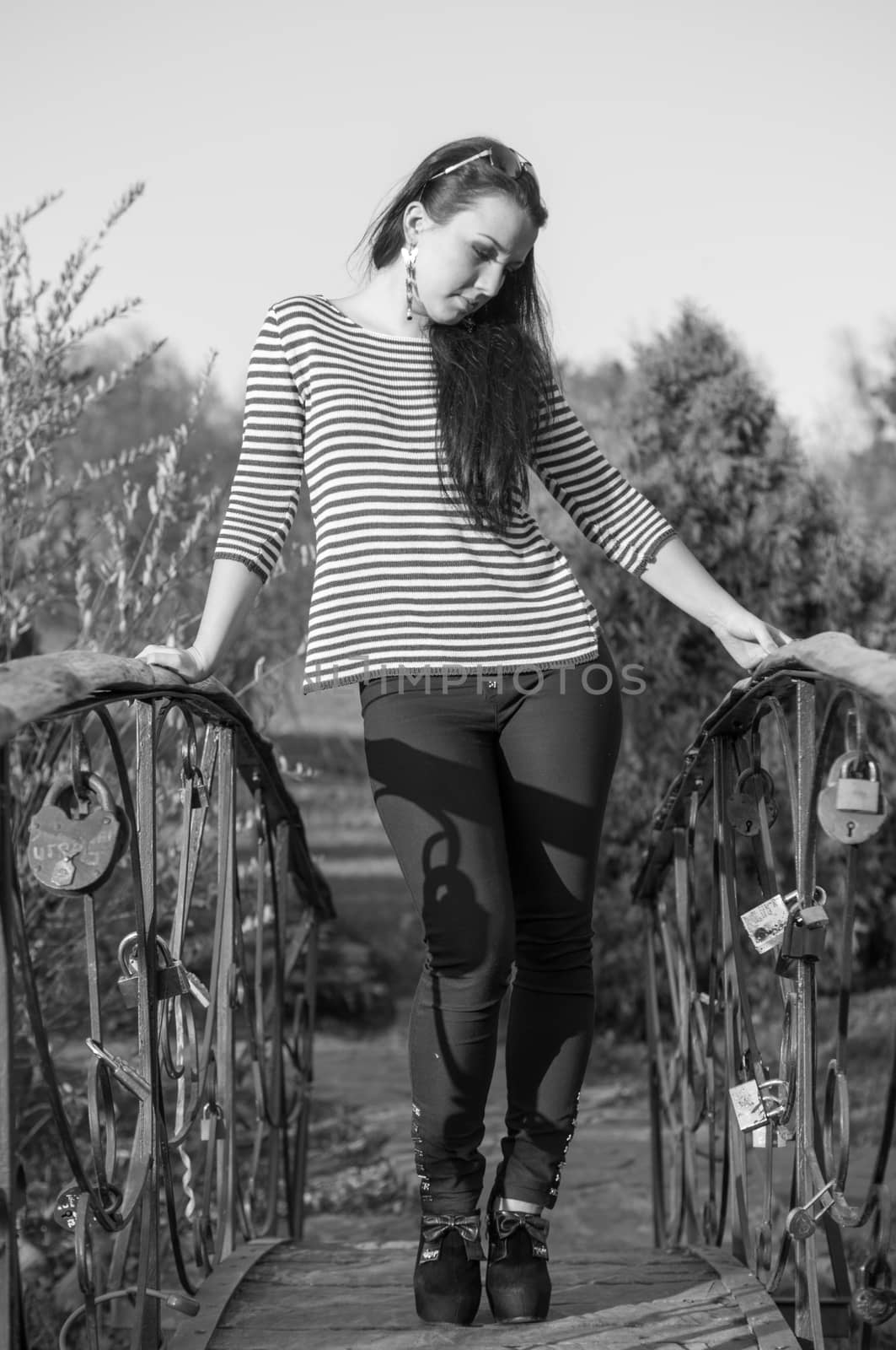 beautiful and sexy girl sitting on bench outdoors. 