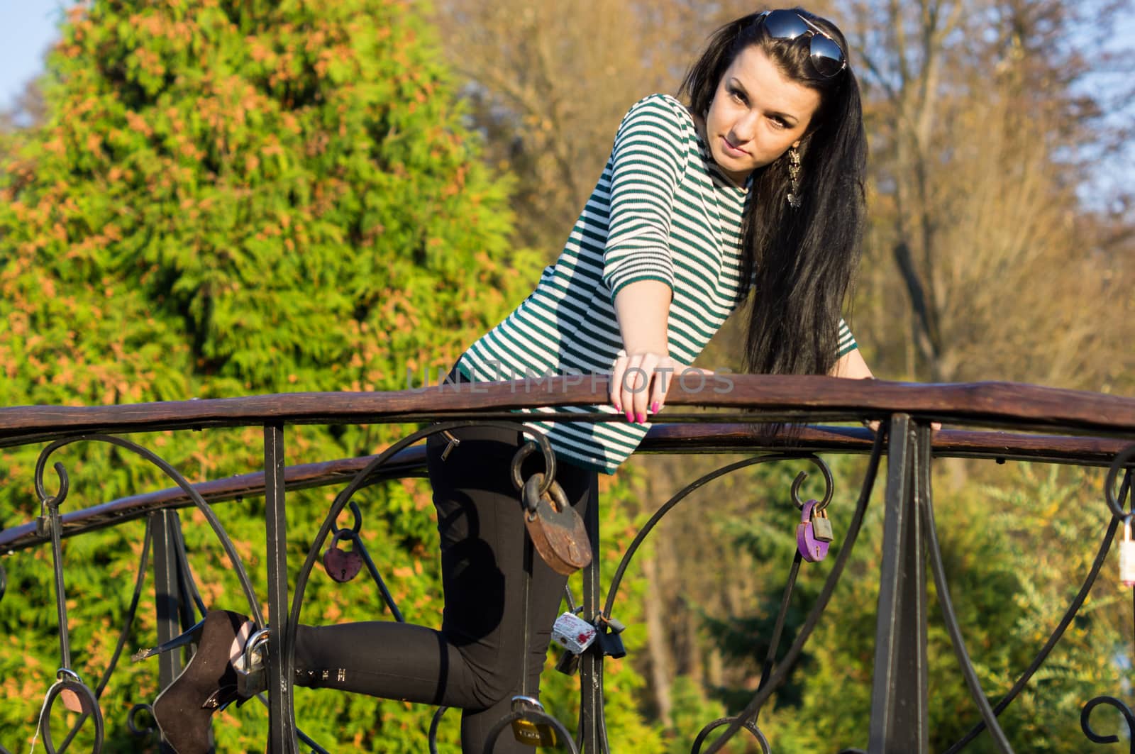 beautiful and sexy girl sitting on bench outdoors. 