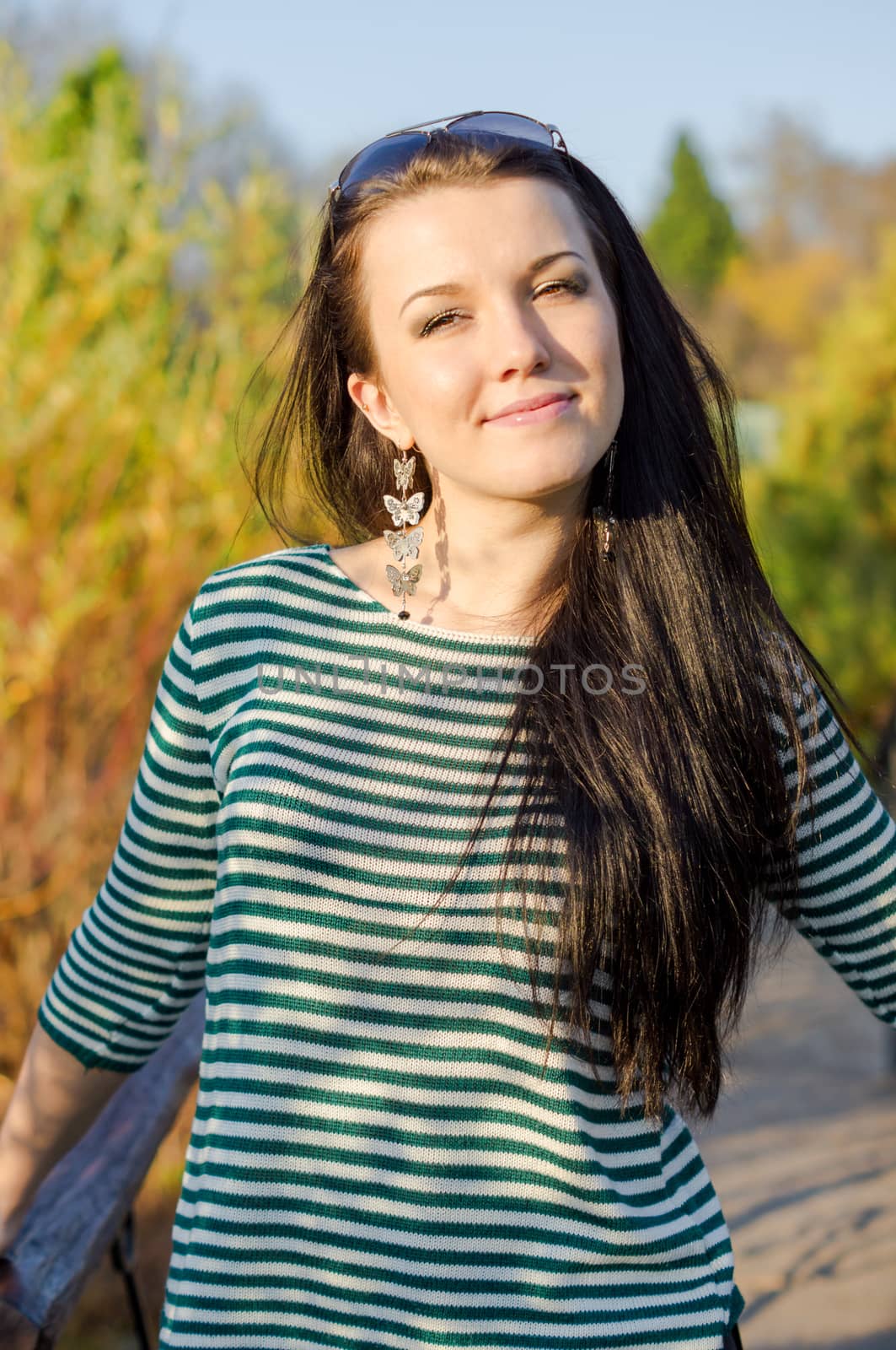 beautiful and sexy girl sitting on bench outdoors. 