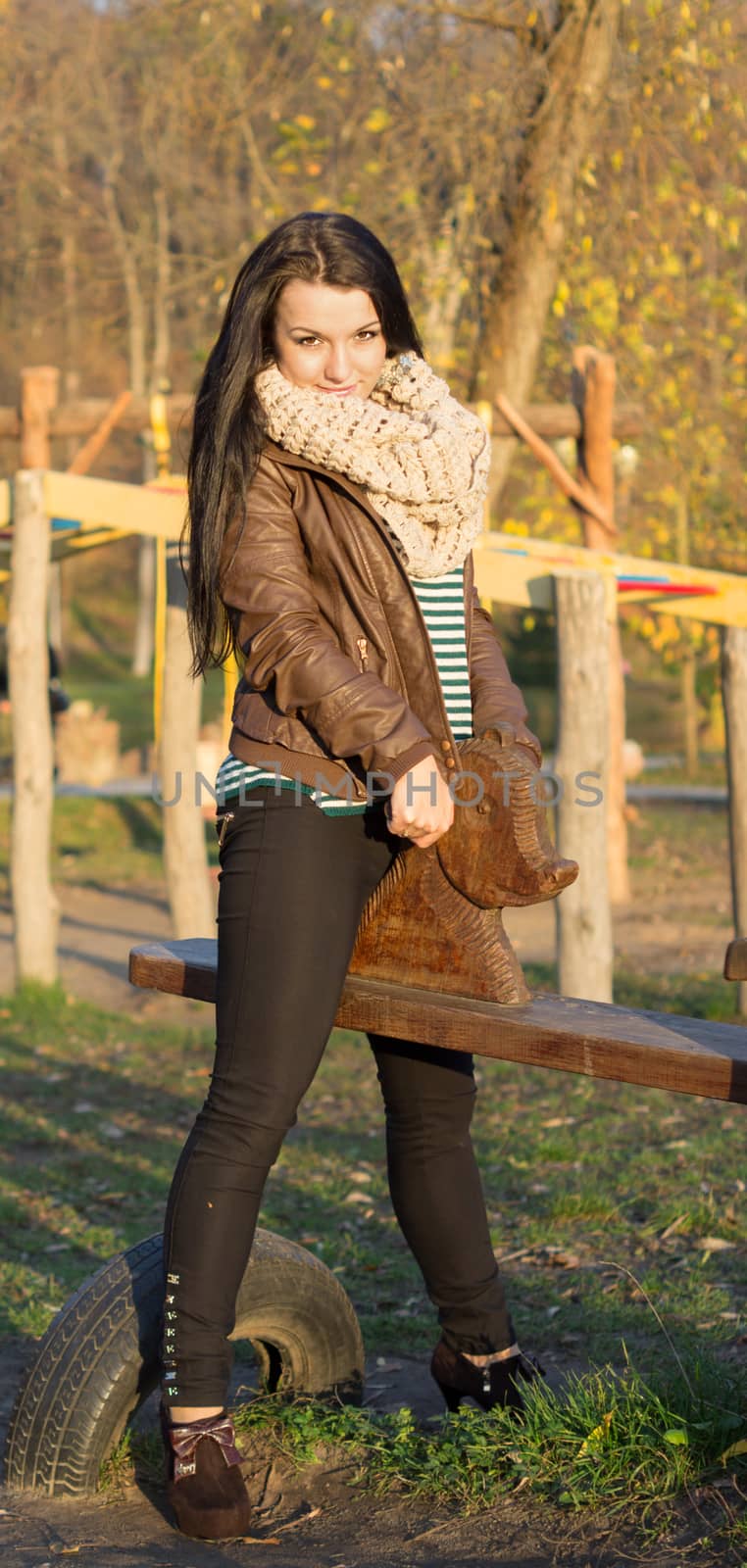 beautiful and sexy girl sitting on bench outdoors. 