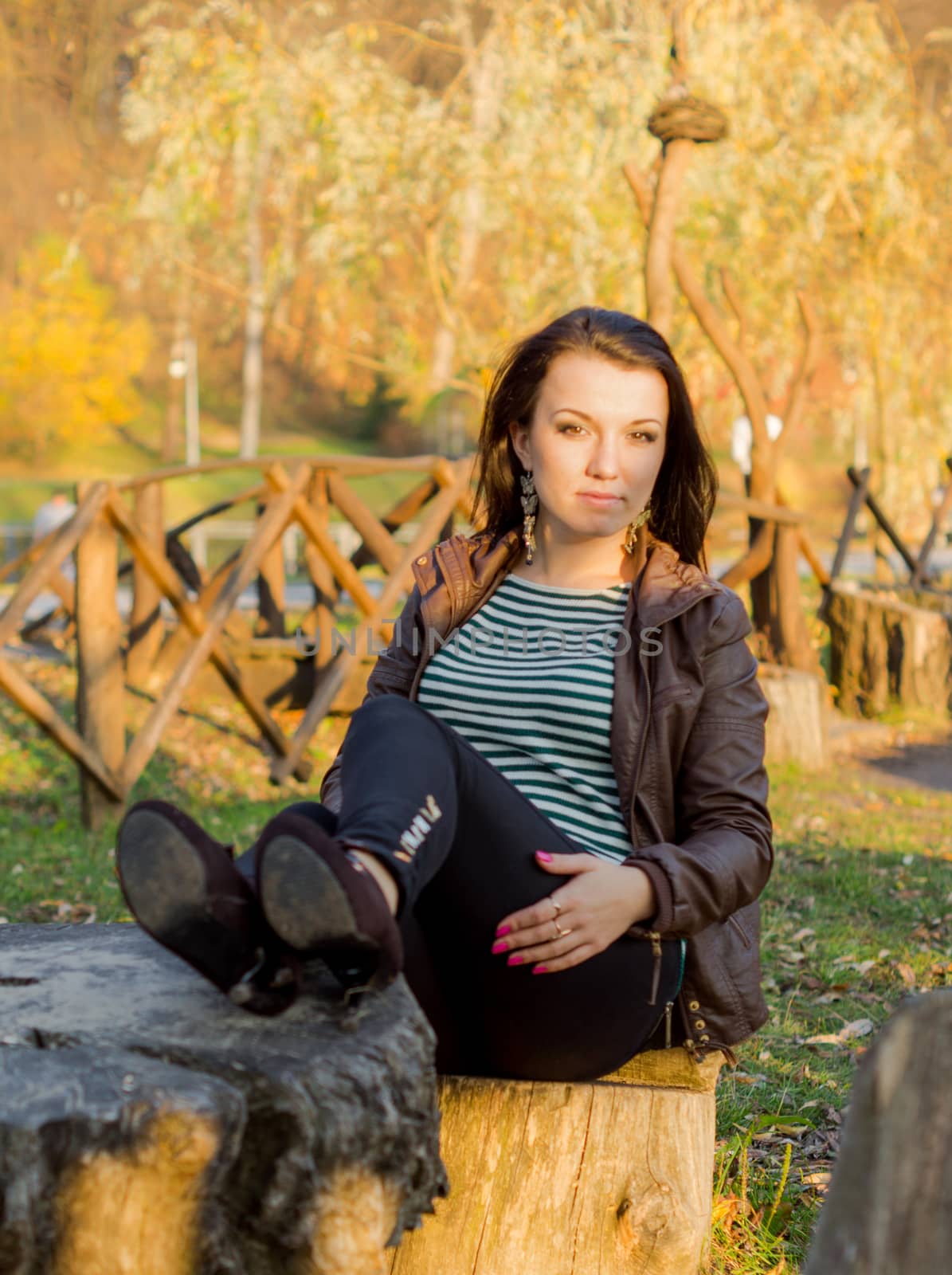 beautiful and sexy girl sitting on bench outdoors by serhii_lohvyniuk