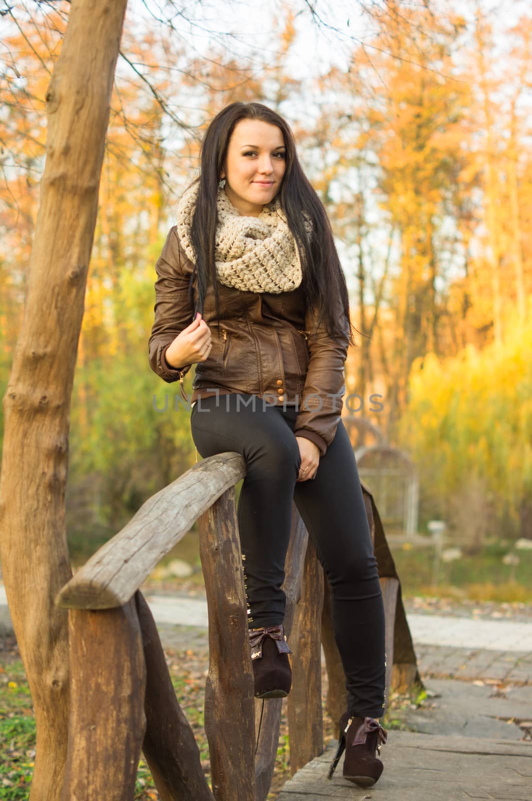 beautiful and sexy girl sitting on bench outdoors by serhii_lohvyniuk