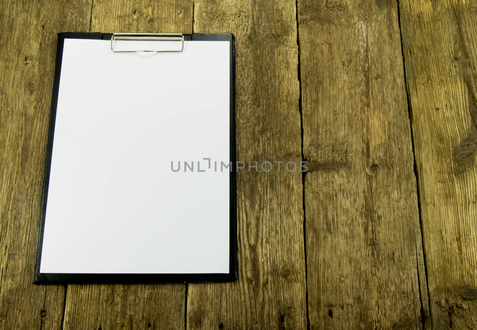 White paper on wood background. For your commercial and editorial use