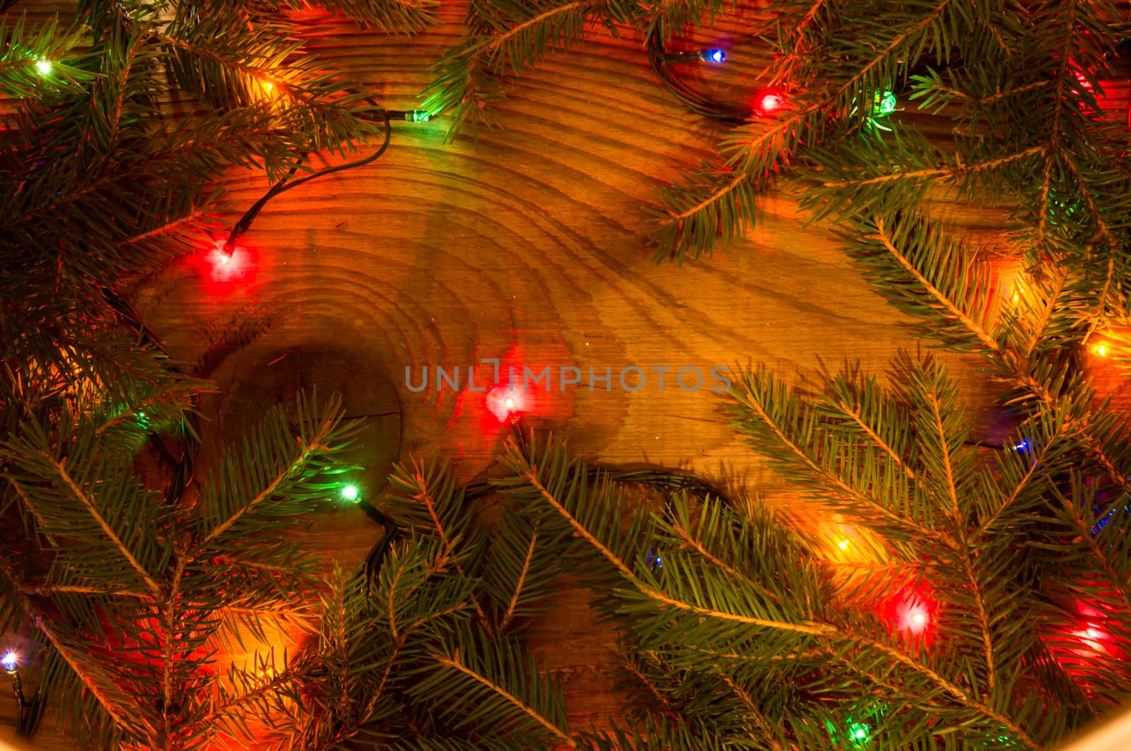 Christmas lights on wooden background by serhii_lohvyniuk