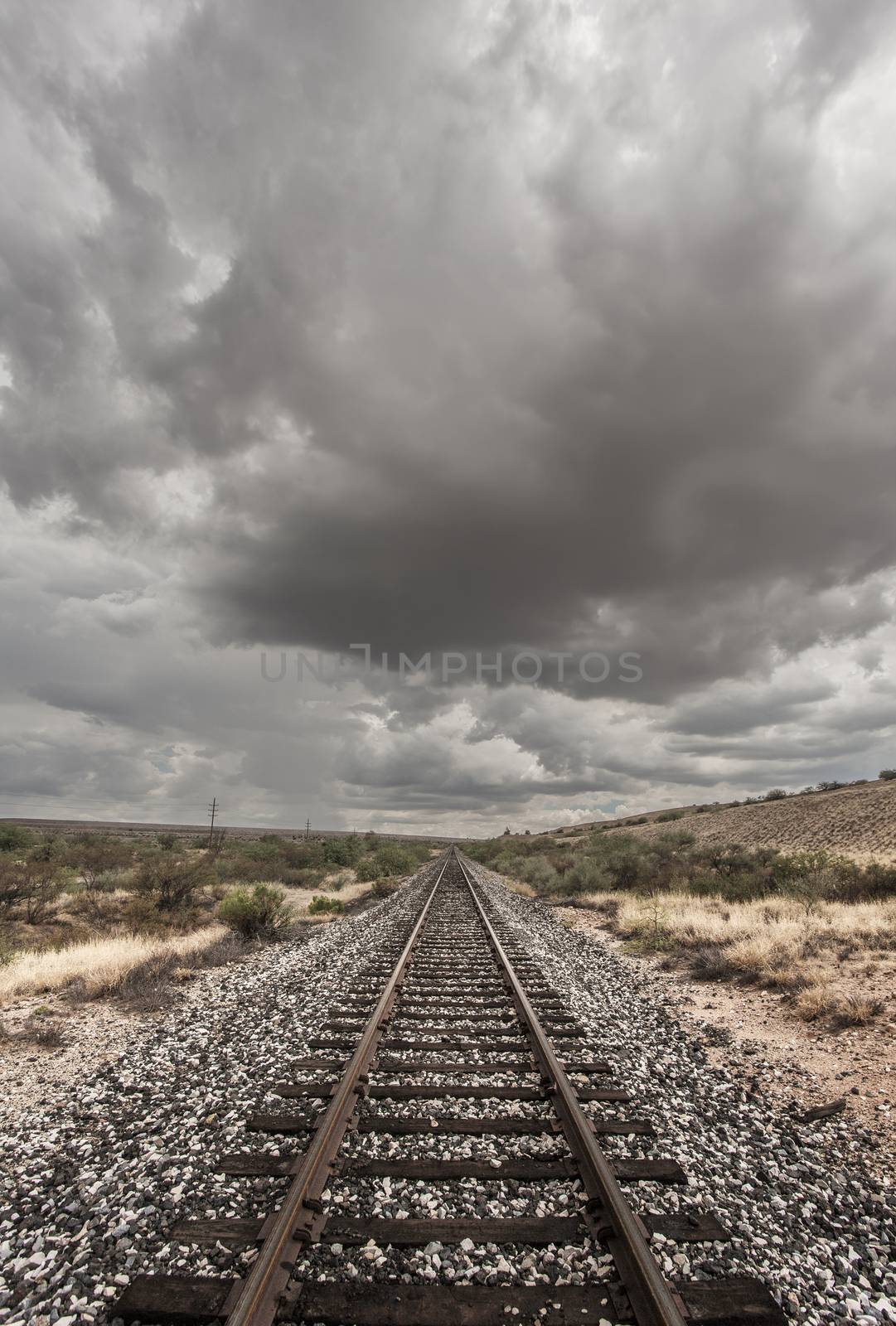 Single railroad track with monsoon clouds above