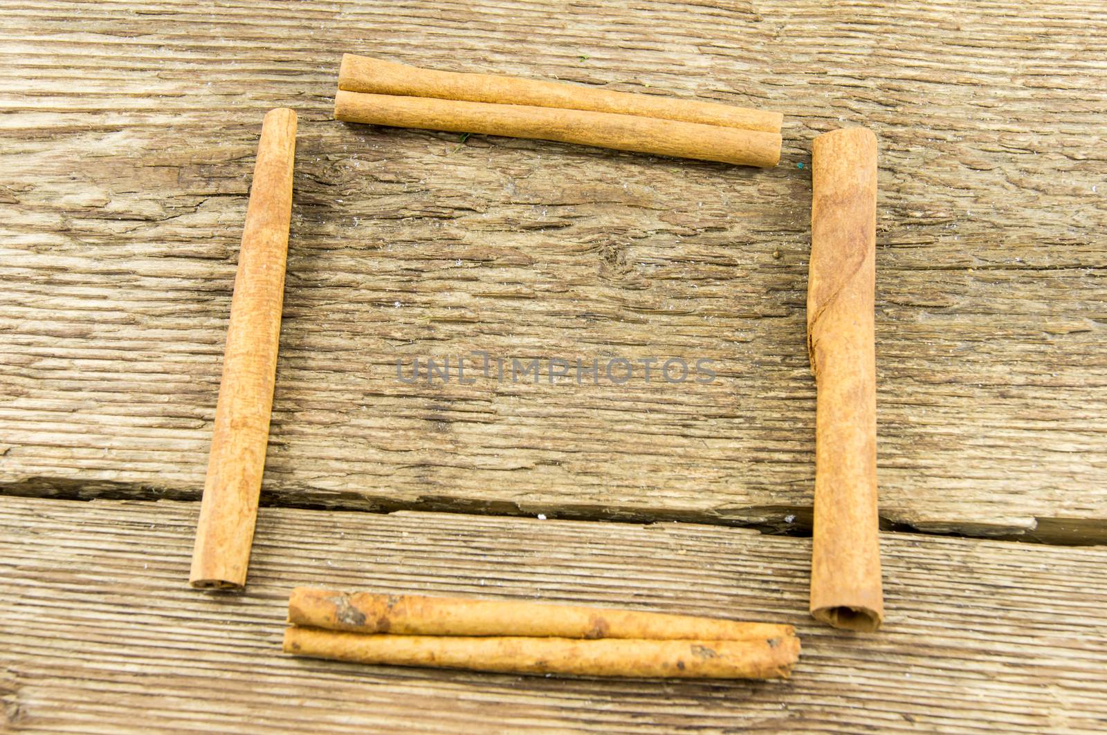 Close up of cinnamon sticks on rustic wood . For your commercial and editorial use.
