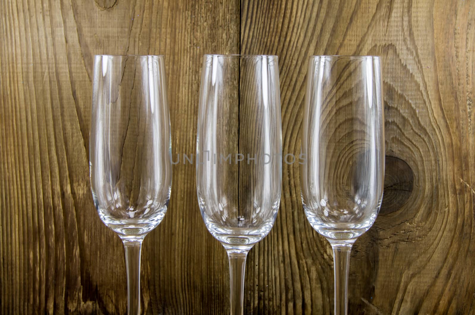 glass with champagne on a wooden background by serhii_lohvyniuk