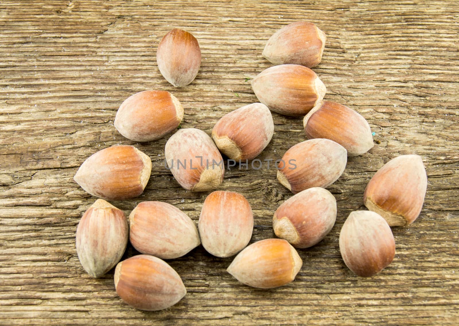 Filberts on a wooden table. Close-up shot. by serhii_lohvyniuk