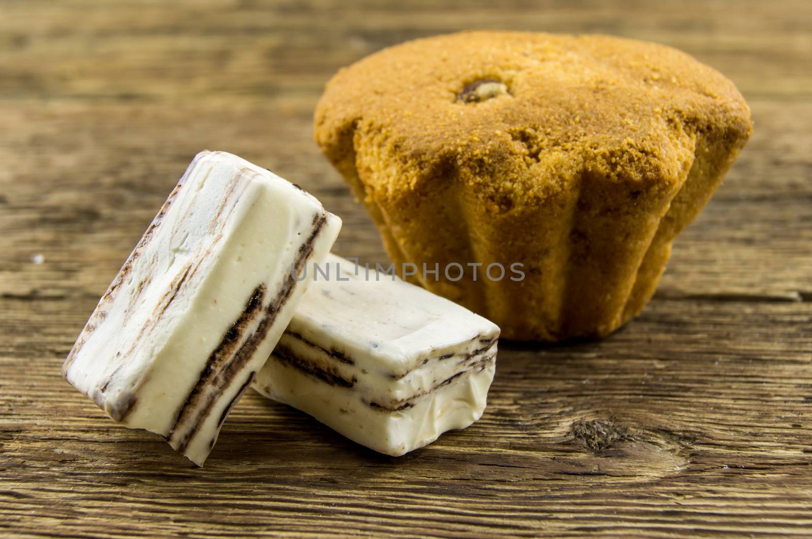 Tasty cupcake on wooden table. For your commercial and editorial use.